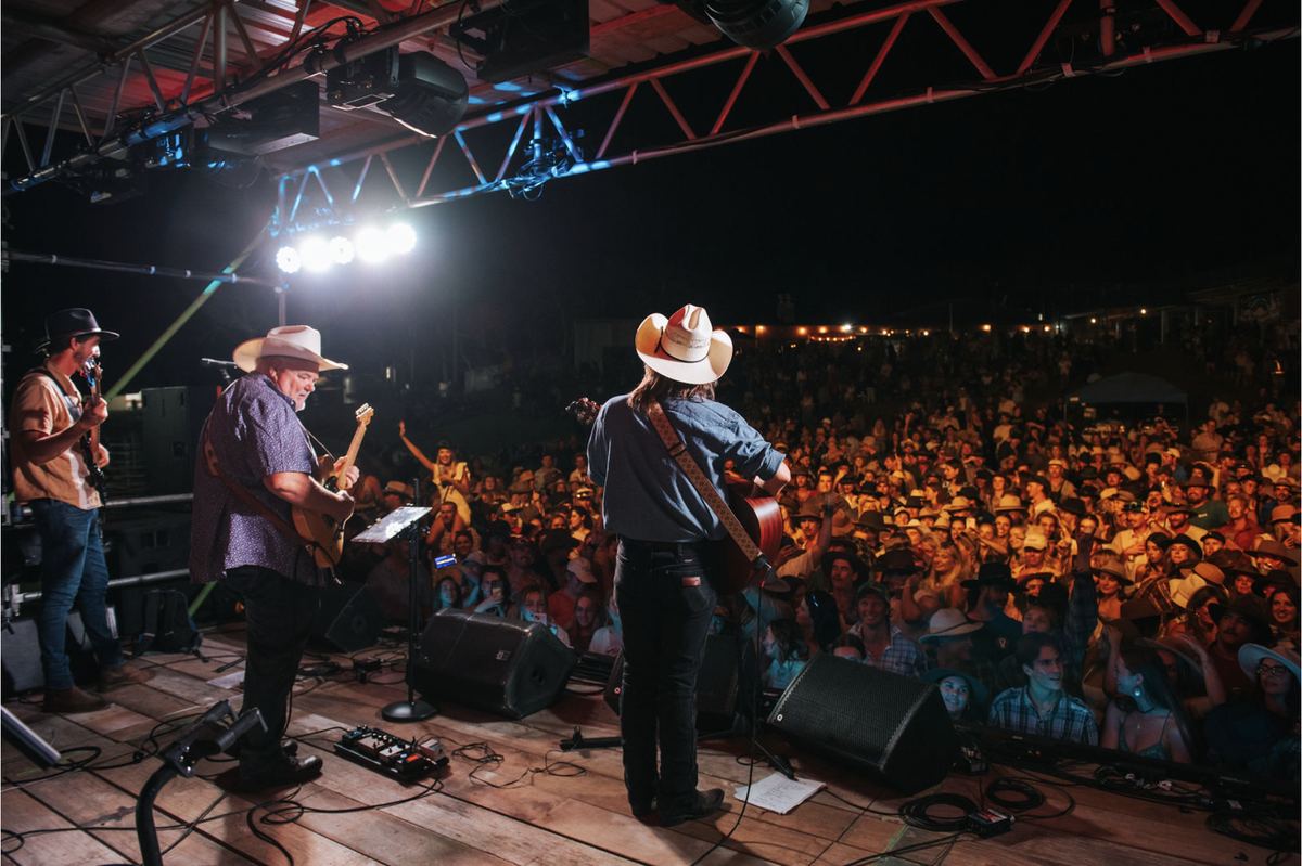 Dave Kent performing on a festival stage with his band